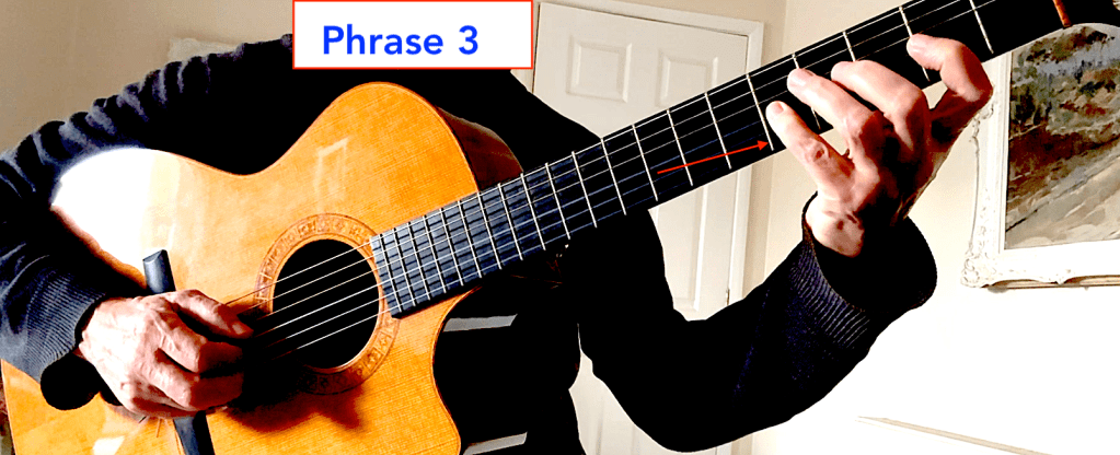 A guitarist demonstrating finger placement on the neck of an acoustic guitar, labeled 'Phrase 3' of alternate picking guitar technique.